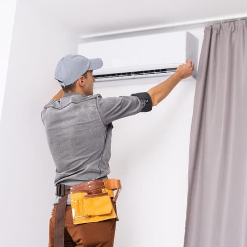 Technician working on an air conditioner