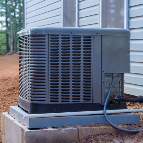 AC compressor outside of a home